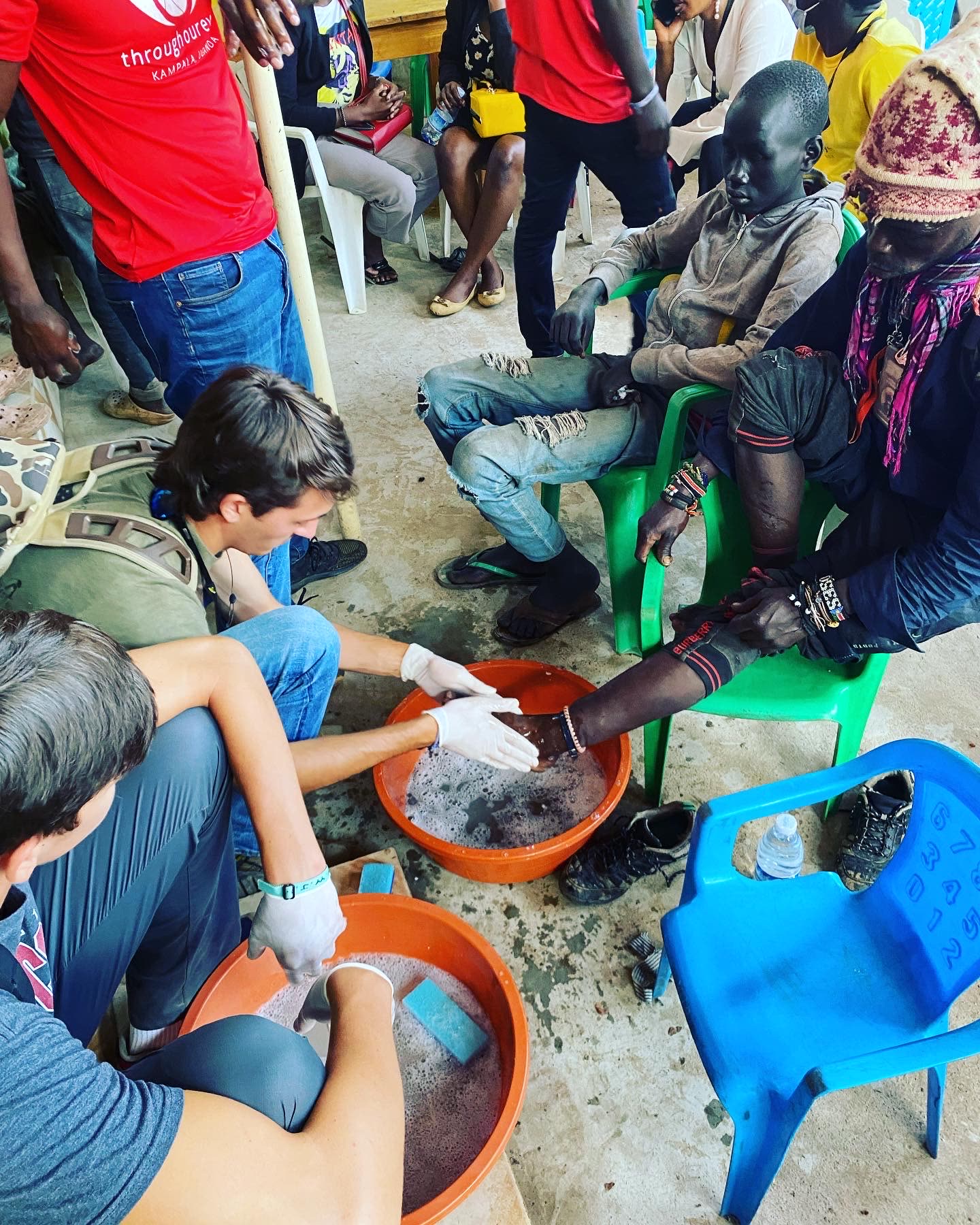 A mission team washing feet and caring for people in Uganda