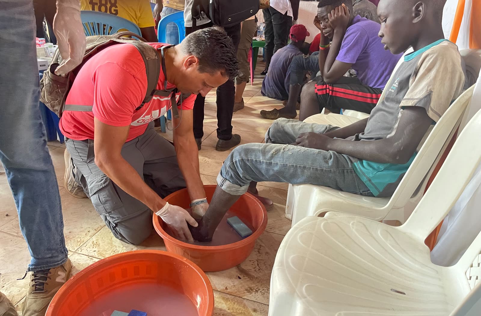 Chuckie washing a young man’s feet in Uganda
