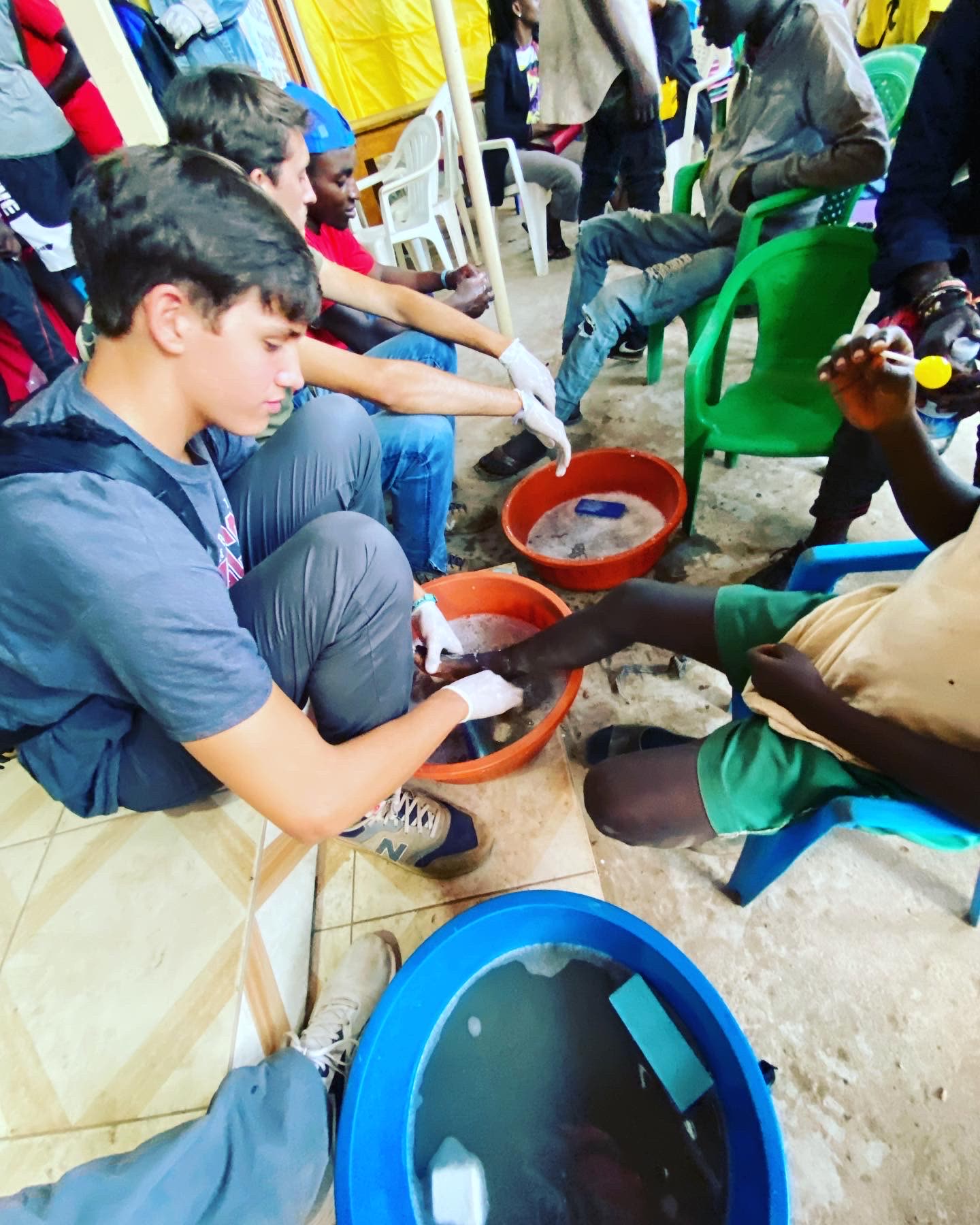 Young men serving side by side during mission work in Uganda